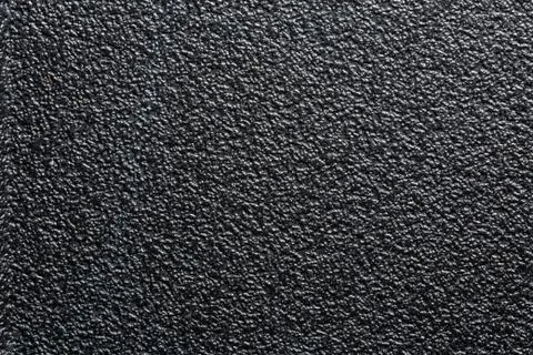 Flat black rugged plastic or rubber surface with decorative bumpy finish Stock Photos