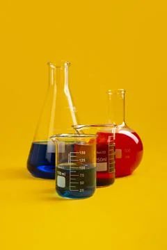 Flat bottom flask, conical flask and two Berzelius beaker glasses lay against Stock Photos