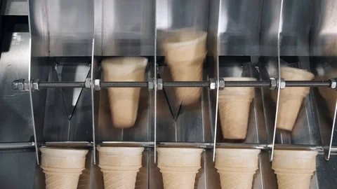 Flat bottom waffle cups move on separating equipment closeup Stock Footage 125008897