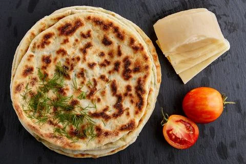 Flat bread with cheese and herbs and yoghurt sauce Stock Photos