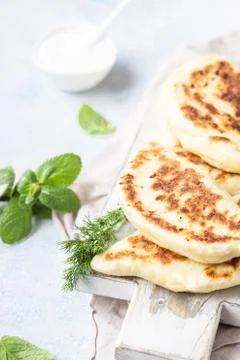 Flat bread with fresh herbs and yogurt dressing. Stock Photos