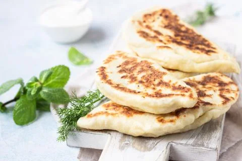 Flat bread with fresh herbs and yogurt dressing. Stock Photos