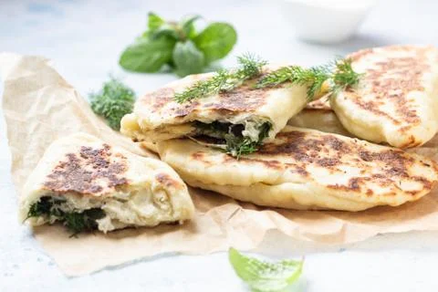 Flat bread with fresh herbs and yogurt dressing. Stock Photos
