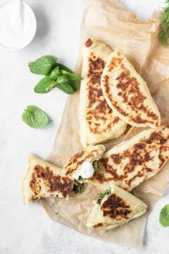 Flat bread with fresh herbs and yogurt dressing. Stock Photos