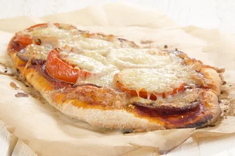 Flat bread pizza with tomato and salami Stock Photos