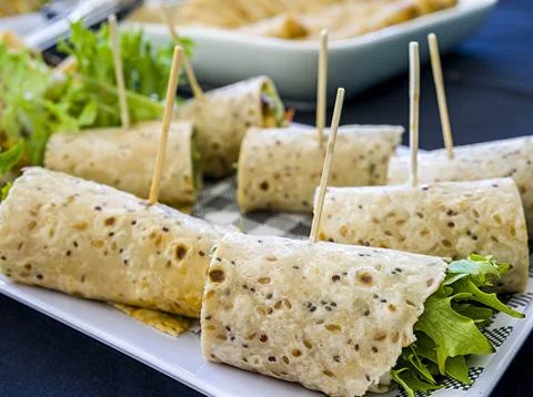 Flat bread wrapped with green lettuce and other ingredients Stock Photos