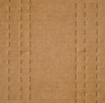 Flat brown cardboard  background texture with perforated lines that will help Stock Photos