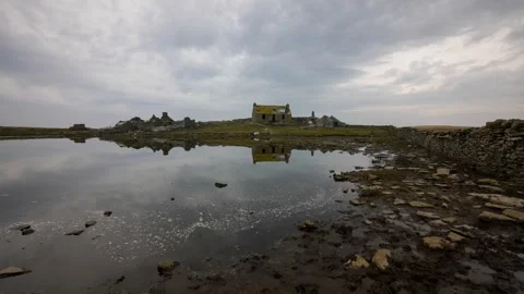 Flat calm with reflections in the water on swona in orkney in 4k Stock Footage 303847043
