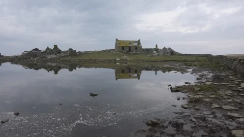 Flat calm water with mirror reflections on Swona in Orkney in 4k Stock Footage 304004264