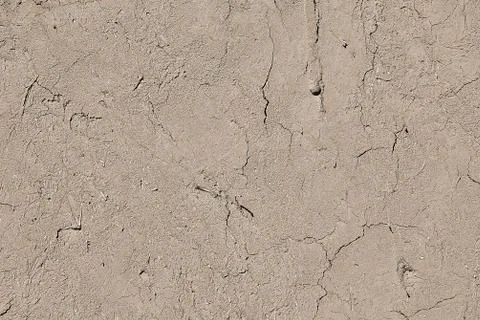 Flat clay plaster in cracks, wall fence, texture for backdrop. Stock Photos