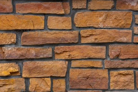 Flat close-up full frame background and texture of decorative orange stone .. Stock Photos