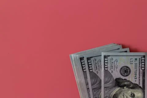 Flat closeup of dollars on pink background. Investment profit income. Success Stock Photos