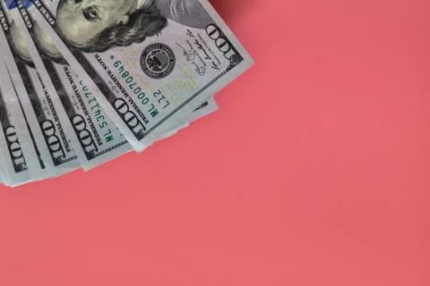 Flat closeup of dollars on pink background. Investment profit income. Success Stock Photos