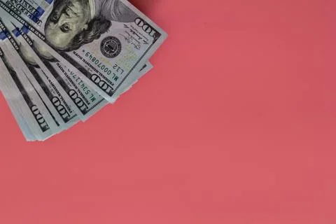 Flat closeup of dollars on pink background. Investment profit income. Success Stock Photos