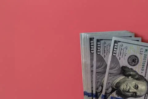 Flat closeup of dollars on pink background. Investment profit income. Success Stock Photos