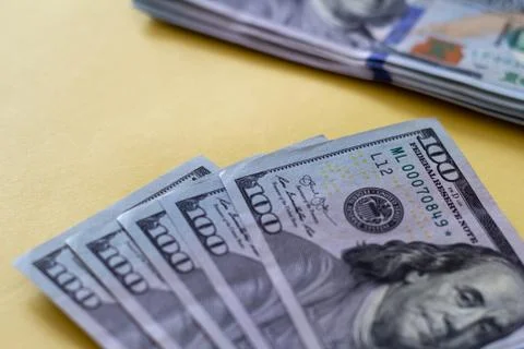 Flat closeup of dollars on yellow background. Investment profit income. Succe Stock Photos