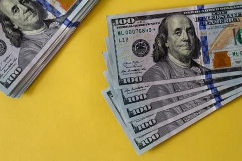 Flat closeup of dollars on yellow background. Investment profit income. Succe Stock Photos