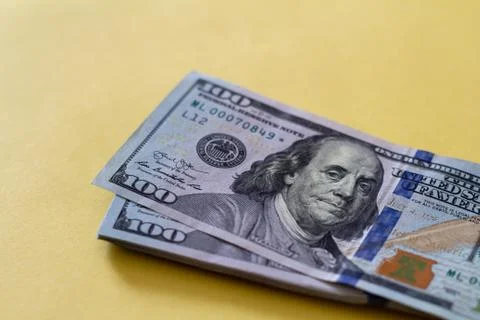Flat closeup of dollars on yellow background. Investment profit income. Succe Stock Photos
