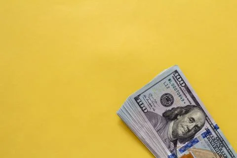 Flat closeup of dollars on yellow background. Investment profit income. Succe Stock Photos