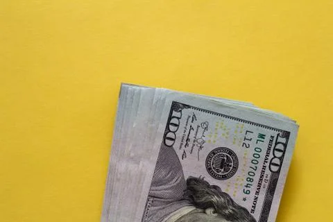 Flat closeup of dollars on yellow background. Investment profit income. Succe Stockfoto's
