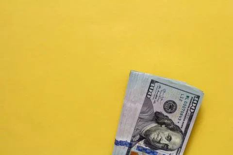Flat closeup of dollars on yellow background. Investment profit income. Succe Stock Photos