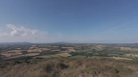 Flat color hilltop field overview under clear blue sky Stock Footage 340445471