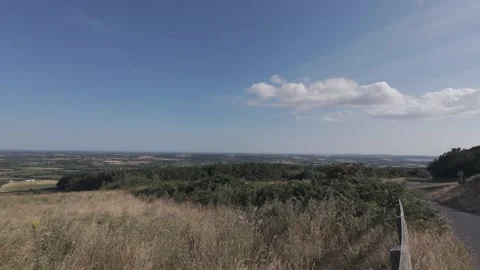 Flat color wide view of countryside hills under clear blue sky Stock Footage 340444766