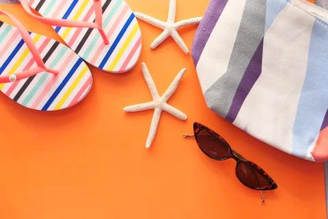 Flat composition of summer beach accessories on orange background Stock Photos