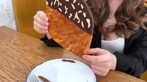The Flat croissant with chocolate and sprinkle of nuts served in white plate Stock Footage 276223506