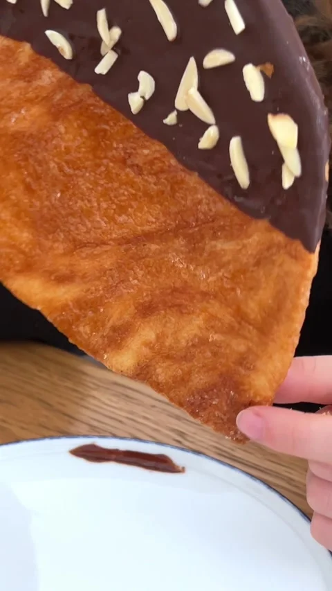 The Flat croissant with chocolate and sprinkle of nuts served in white plate Stock Footage 276334393