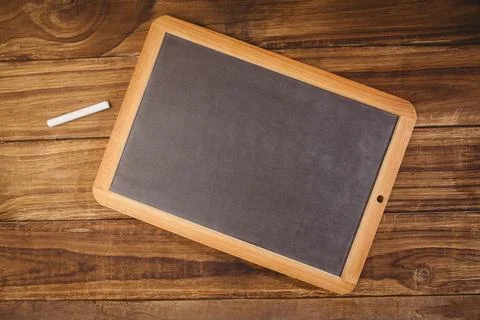 Flat design art is showing diagonal framed blackboard on rustic wooden table Stockfoto's
