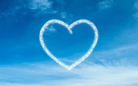 Flat design showing bright blue sky forming heart-shaped cloud amid wispy cloud Ilustración de archivo