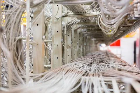 Flat design is showing dense assembly of unshielded data cables on metal rack Stock Photos