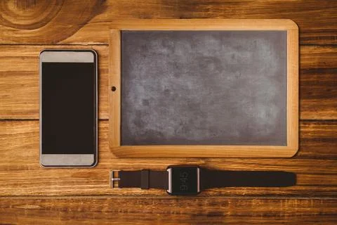 Flat design is showing top-down smartphone, chalkboard, smartwatch placed on Stock Photos