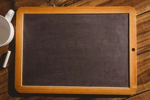 Flat design showing wood-framed chalkboard is lying on plank tabletop, with Stock Illustration