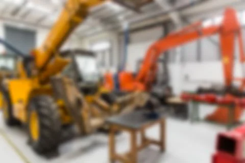 Flat design showing workshop with yellow backhoe loader raising bucket, robotic Stock Illustration