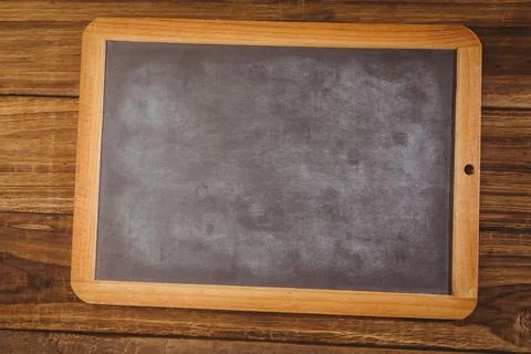 Flat design wood frame chalkboard is sitting on rustic tabletop showing chalk Stock Illustration