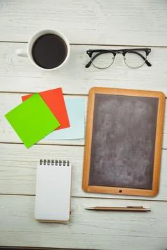 Flat design workspace is showing coffee cup, glasses, sticky notes, chalkboard 写真素材