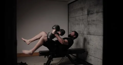 Flat dumbbell bench press, cinematic lighting, white man dressed in black Stock Footage 254761867
