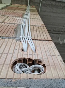 Flat electric cables on the wall Stock Photos