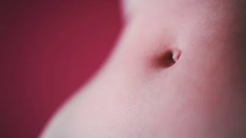 On the flat female tummy flows red paint Stock Footage 81697779