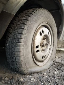 Flat front tire on car Stock Photos