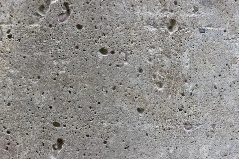 A flat grey concrete textured surface covered in air bubbles Stock Photos