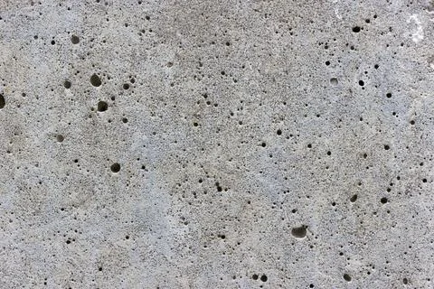 A flat grey concrete textured surface covered in air bubbles Stock Photos