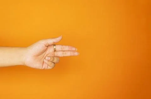Flat Hand Gesture on Orange Background for Marketing Design Stock Photos