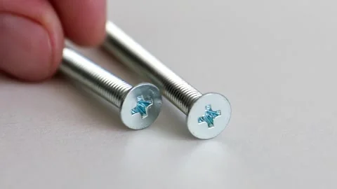 Flat Head Phillips Machine Screws on White Background Close Up Stock Footage 333773934