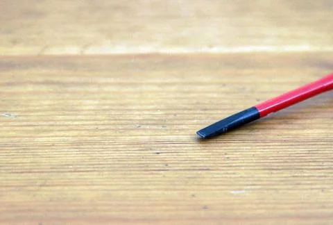 Flat head VDE screwdriver put on wood Stock Photos