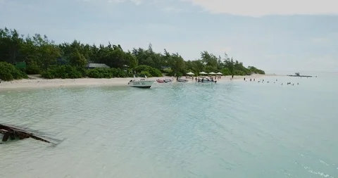 Flat Island, Mauritius - May 19. 2019; Backward flight above the sendy beach  Stock Footage 109168359