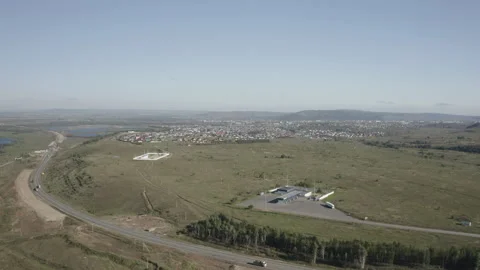Flat land split by busy road while small lakes appear in distance Stock Footage 303111009