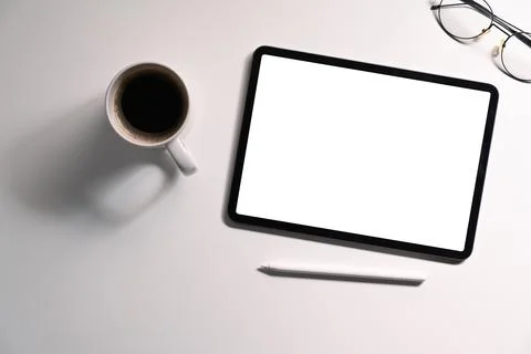 Flat lat digital tablet with empty display, coffee cup and eyeglasses on white Stock Photos